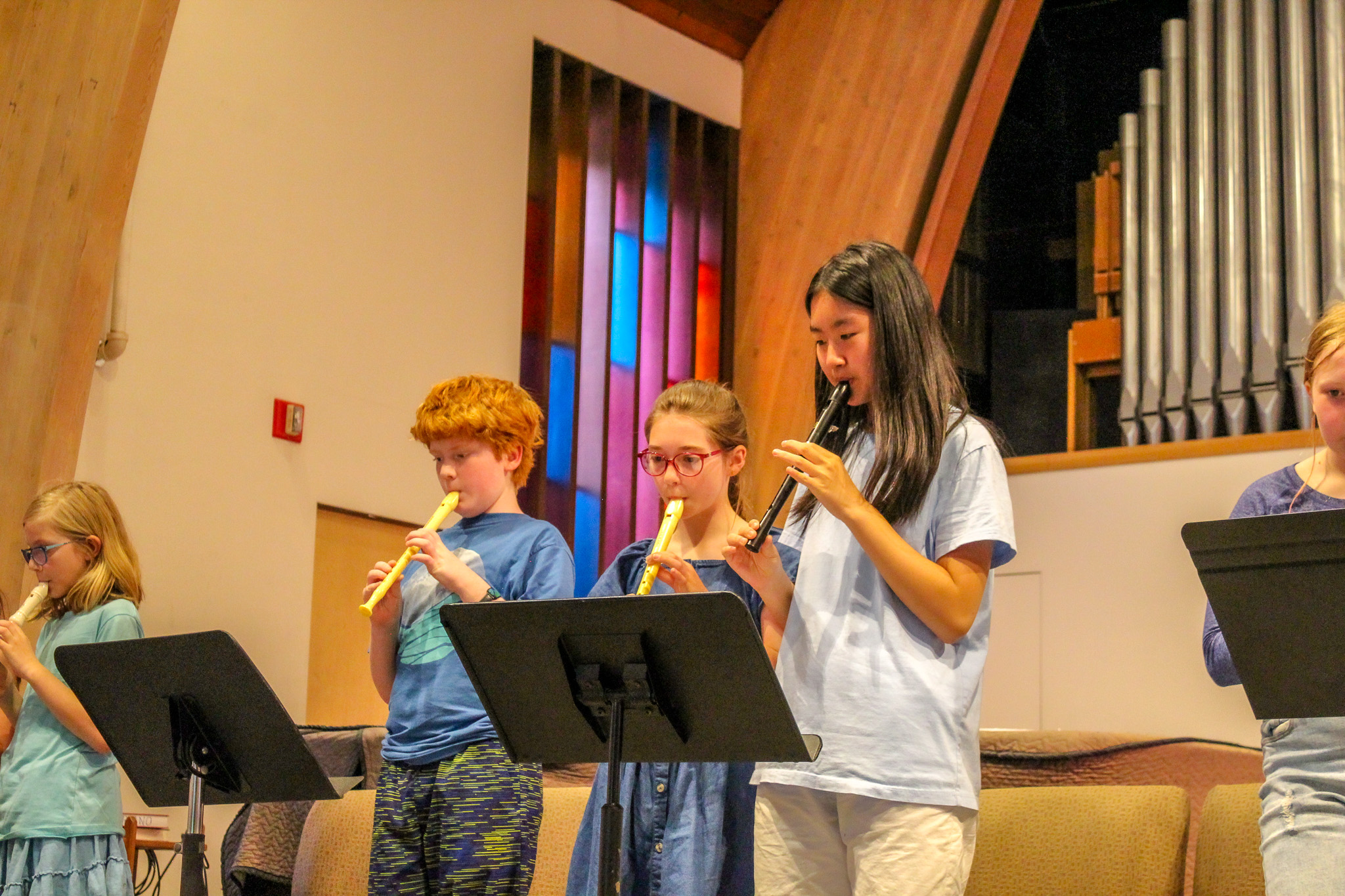 Elementary students playing recorders while performing at a school concert