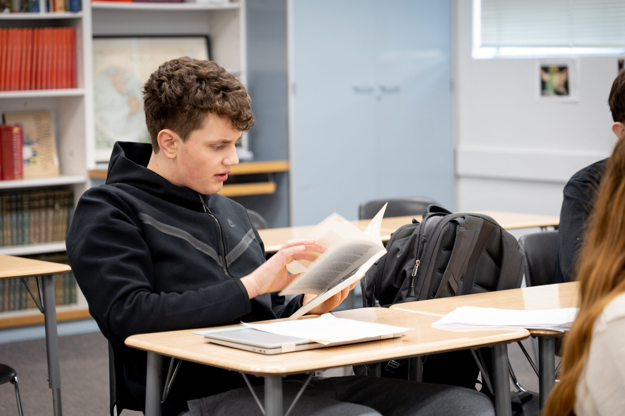 High school student reading during class