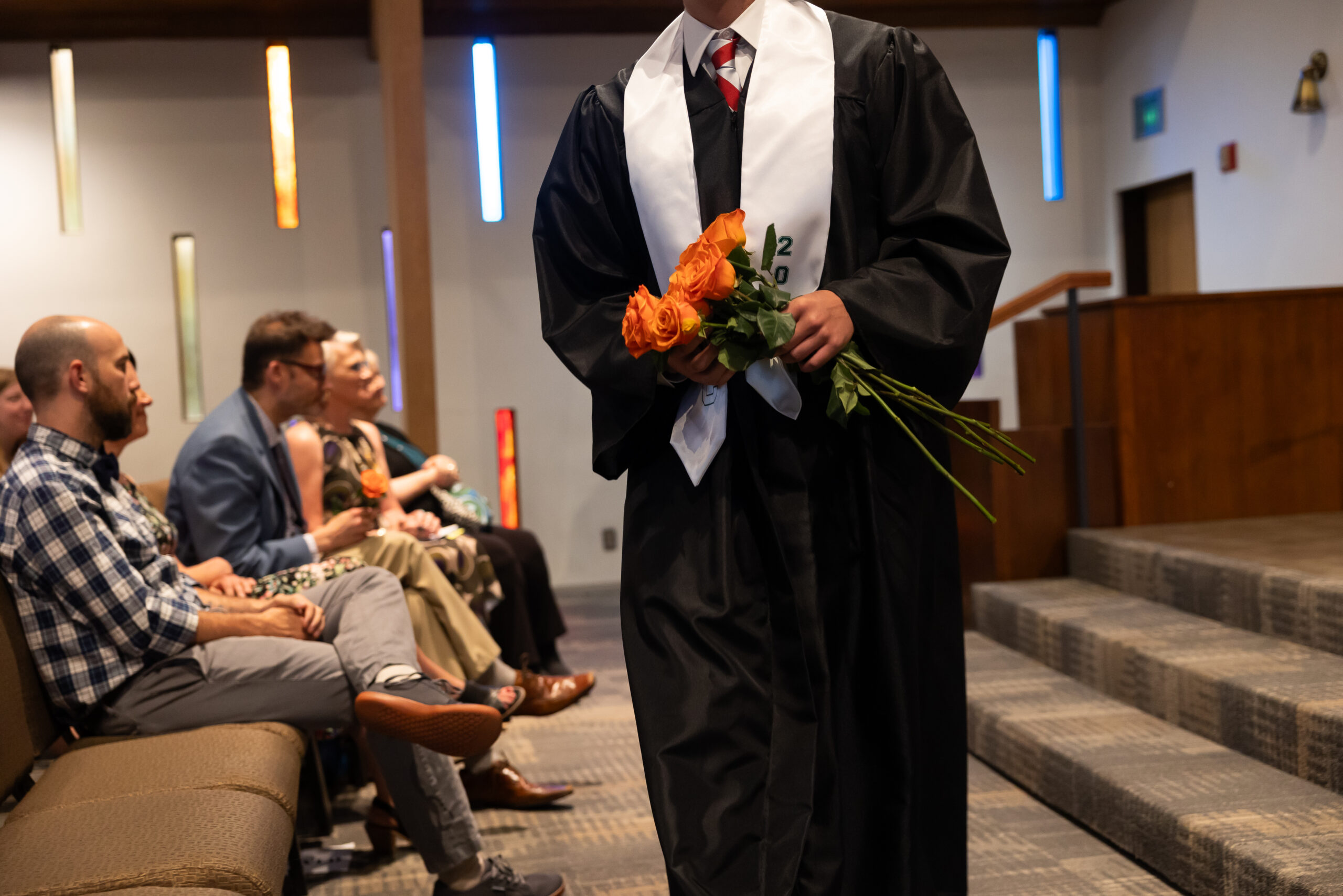 Graduate handing out roses during graduation
